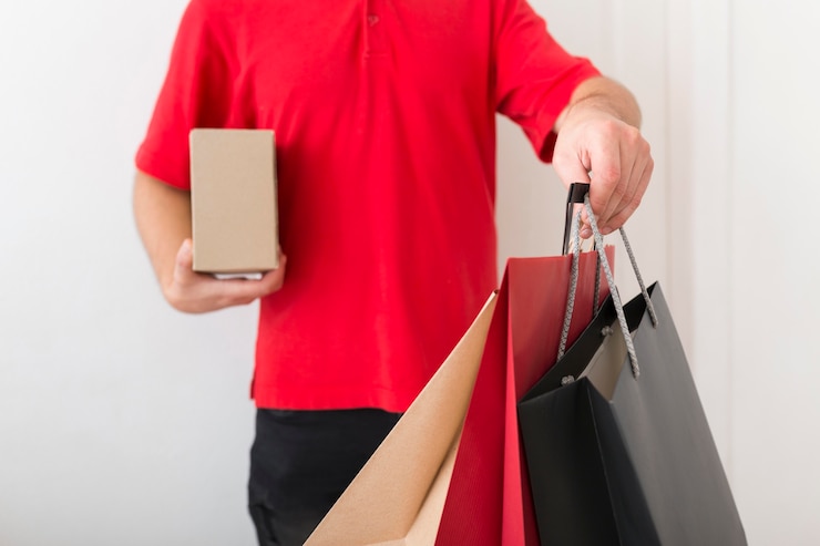 Foto gratuito repartidor con bolsas de la compra.