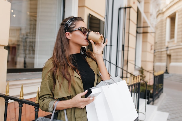 Retrato al aire libre de una elegante mujer obsesionada con las compras