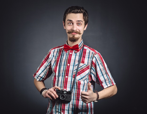 Retrato de un alegre fotógrafo en estudio