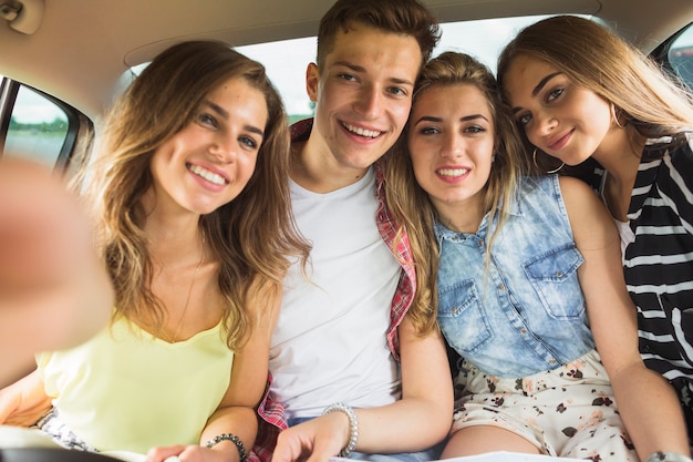 Foto gratuita retrato de amigos felices en el coche