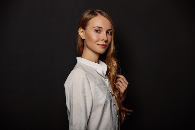 Retrato atractivo de la muchacha en una camisa blanca