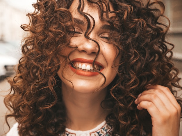 Retrato de la bella modelo sonriente con peinado afro rizos.