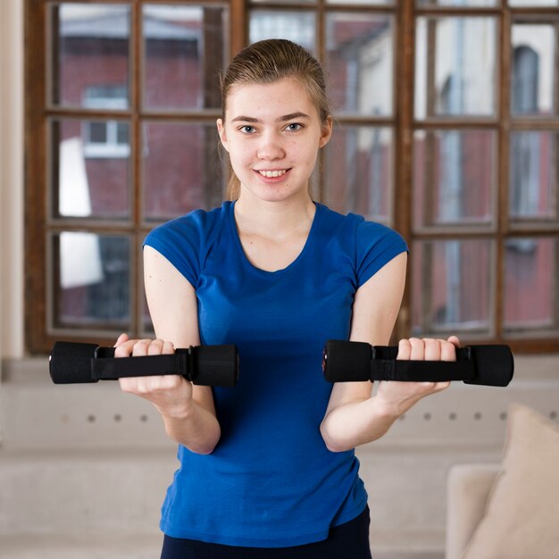 Retrato chica entrenando con pesas