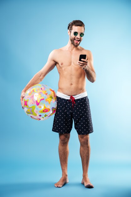 Retrato de un chico guapo con pelota de playa