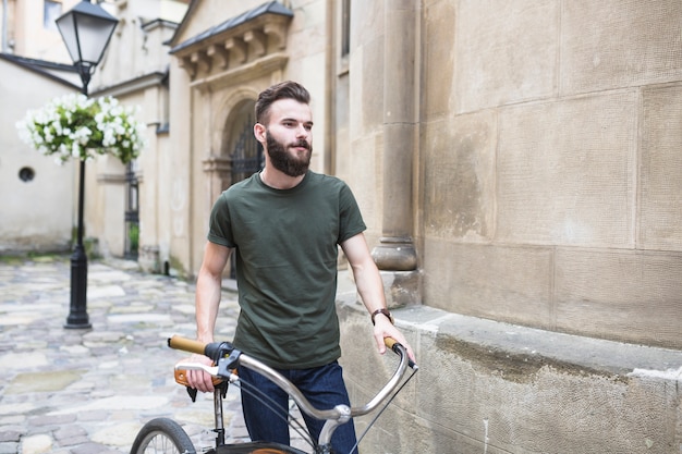 Retrato de un ciclista masculino con su bicicleta