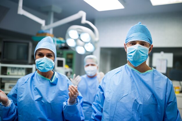 Retrato de cirujanos de pie en la sala de operación