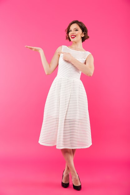 Retrato de cuerpo entero de una niña feliz vestida de vestido