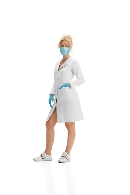 Retrato de doctora en uniforme blanco y guantes azules sobre blanco