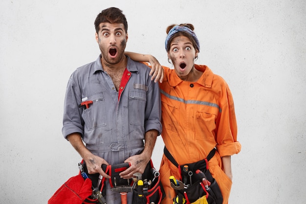 Retrato de electricistas sorprendidos y conmocionados se da cuenta de que cometieron un error durante el trabajo