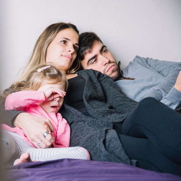 Retrato de una familia que se relaja en cama