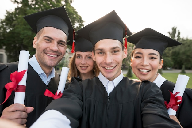 Retrato de grupo de estudiantes celebrando su graduación