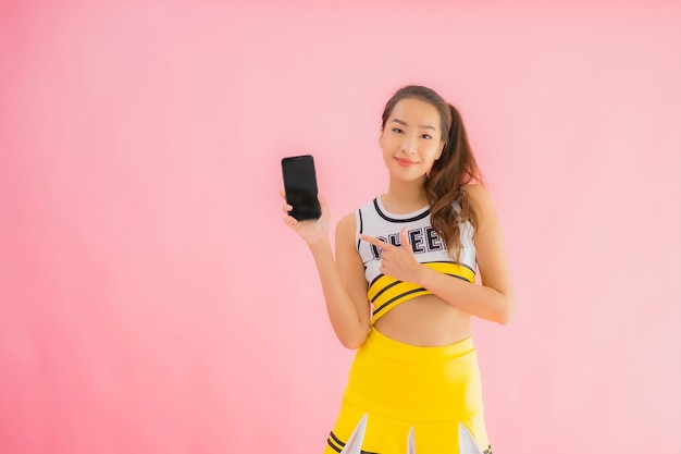 Retrato hermosa animadora joven asiática con teléfono móvil inteligente