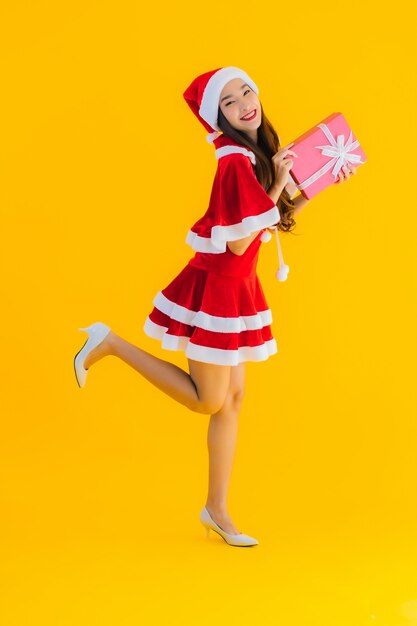Retrato hermosa joven asiática ropa de Navidad y sombrero sonrisa feliz con caja de regalo roja