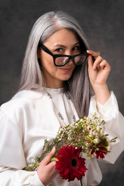 Retrato de hermosa mujer senior con flores