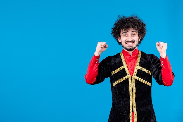 Retrato de hombre azerí feliz en traje tradicional sobre fondo azul bailarina étnica novruz primavera