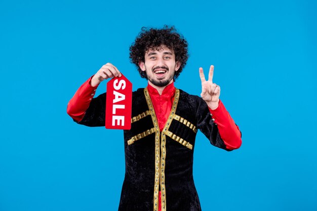 Retrato de hombre azerí en traje tradicional con placa de venta sobre fondo azul color de compras de primavera étnica novruz