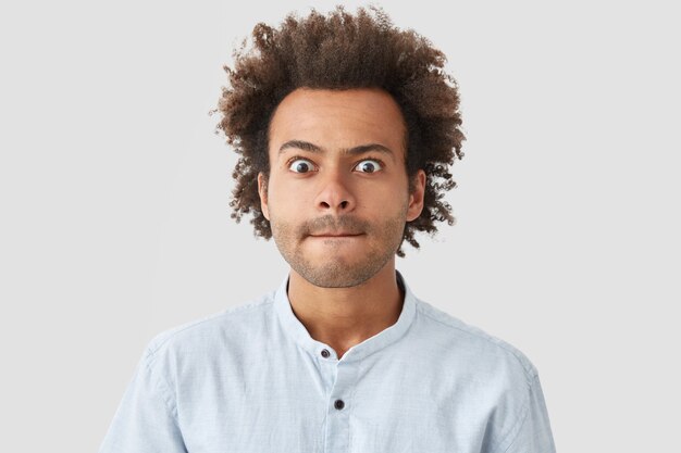 Retrato, de, hombre joven, con, pelo rizado, llevando, camisa