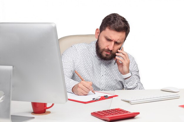 Retrato de hombre de negocios hablando por teléfono móvil en la oficina