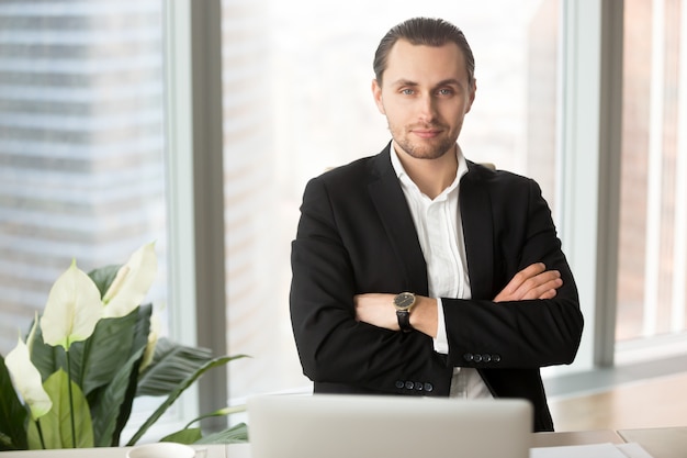 Retrato del hombre de negocios sonriente hermoso en oficina