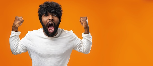 Retrato de hombre negro lleno de alegría celebrando el éxito