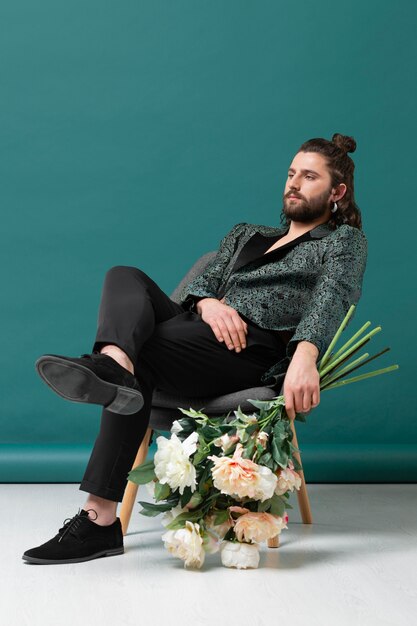 Retrato de hombre en ropa de moda con flores.