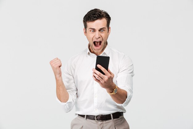 Retrato de un hombre satisfecho feliz mirando el teléfono móvil