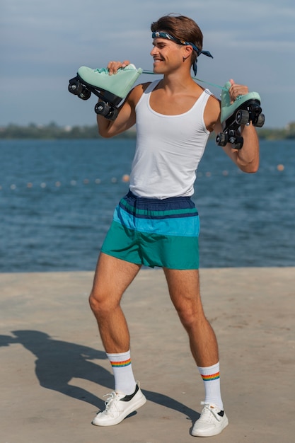 Foto gratuita retrato de hombre en verano con patines en estética de los 80