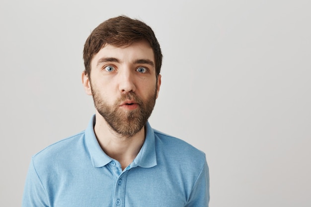 Retrato de un joven barbudo con camiseta azul