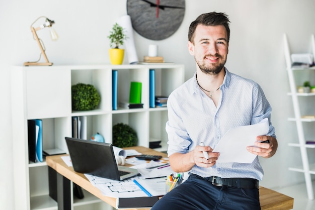 Retrato de un joven empresario feliz con documento