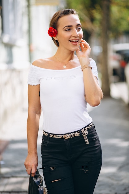 Foto gratuita retrato de joven con flor en el pelo