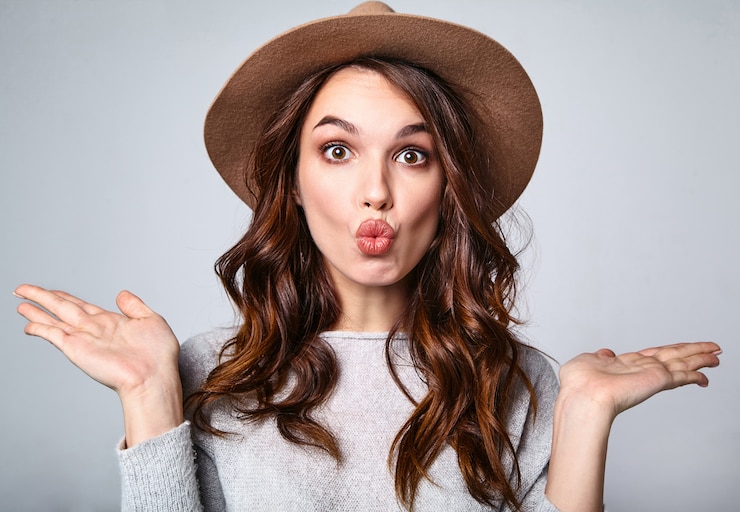 Foto gratuito retrato de joven modelo elegante riendo en ropa casual gris de verano en sombrero marrón