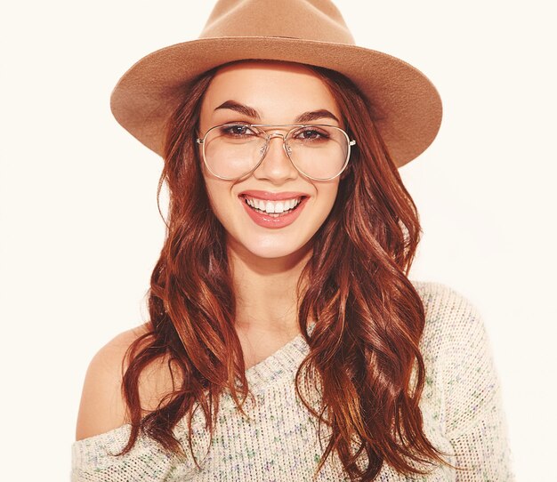 Retrato de joven modelo elegante en ropa casual de verano en sombrero marrón con maquillaje natural en gafas en blanco