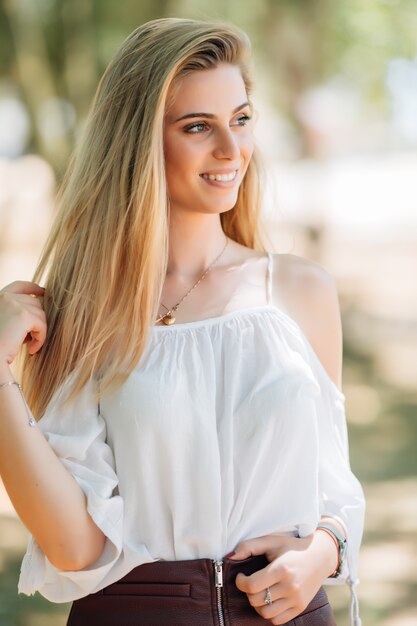 Retrato de joven mujer bonita en el parque de verano