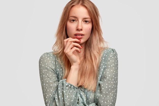 Retrato de joven mujer rubia en elegante blusa