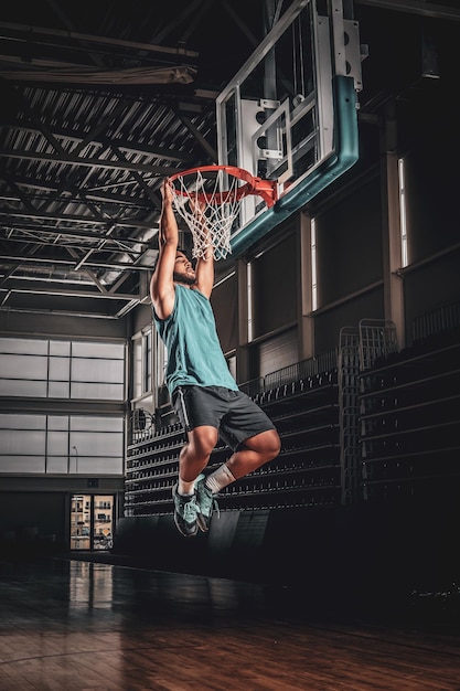 Retrato del jugador de baloncesto negro en una sala de baloncesto