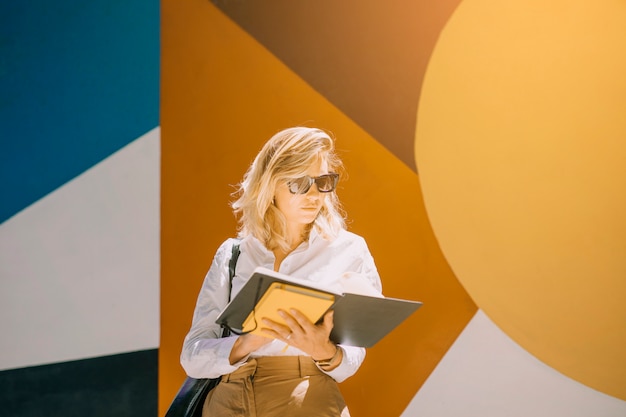 Retrato de un libro de lectura joven de la empresaria que se opone al papel pintado