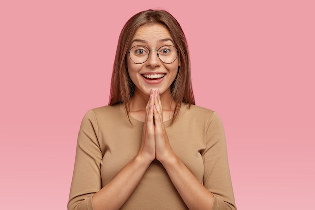 Retrato de linda mujer sonriente tiene expresión positiva