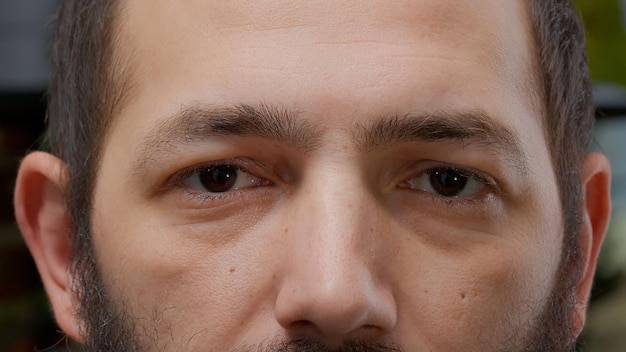 Retrato macro de un hombre sonriendo y mirando a la cámara, con dientes blancos y una vista natural saludable. Modelo que muestra una sonrisa auténtica, un estilo de vida alegre. De cerca.