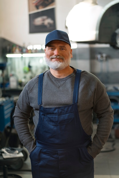 Retrato de mecánico de automóviles masculino en el taller de reparación de automóviles