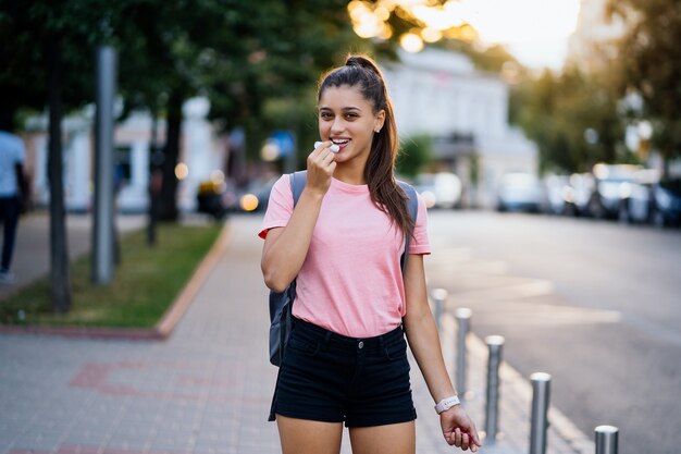 Retrato de moda de estilo de vida de verano de mujer joven con estilo hipster caminando en la calle