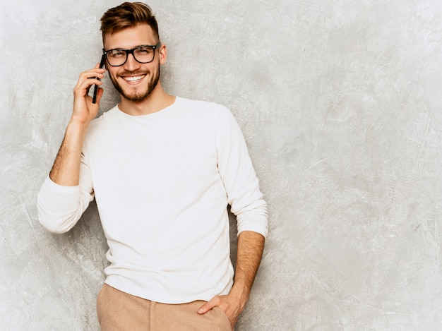 Retrato del modelo sonriente hermoso del hombre de negocios del inconformista que lleva la ropa blanca casual del verano.