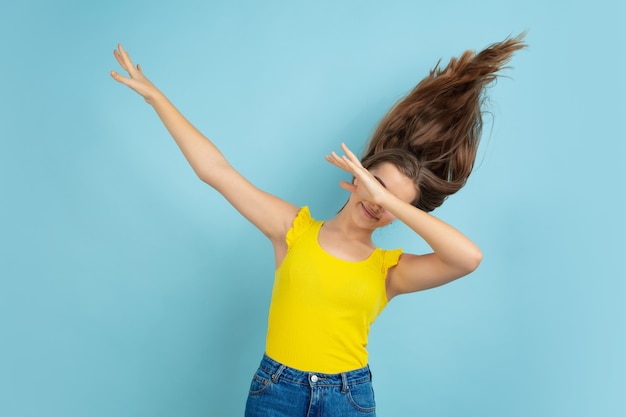 Foto gratuita retrato de muchacha adolescente caucásica aislado en la pared azul del estudio