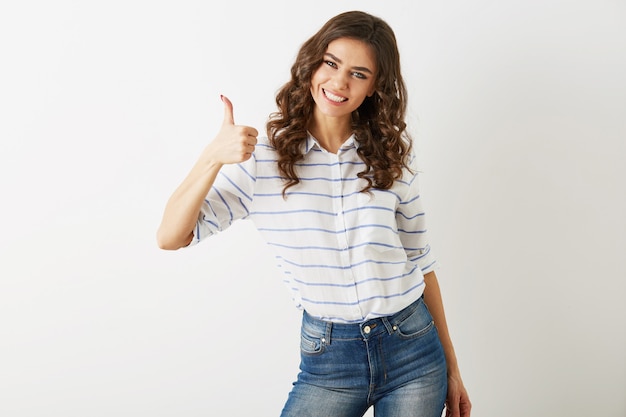 Foto gratuita retrato de mujer atractiva joven vestida con camisa de traje casual y jeans mostrando gesto positivo, sonriente, feliz, estilo hipster, aislado, rizado, pulgar hacia arriba, delgado, hermoso,