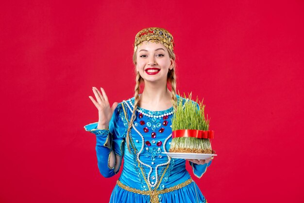 Retrato de mujer azerí en traje tradicional con estudio semeni disparó fondo rojo primavera concepto novruz étnico