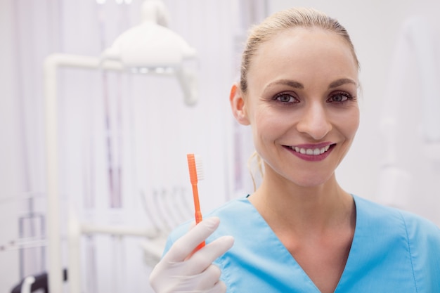 Retrato de mujer dentista con cepillo de dientes