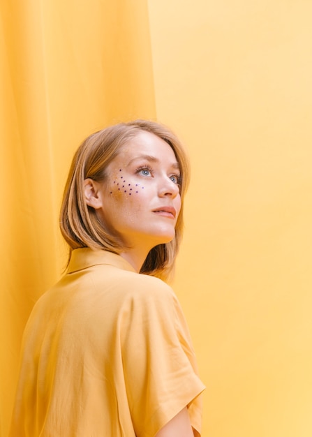 Retrato de mujer en un escenario amarillo