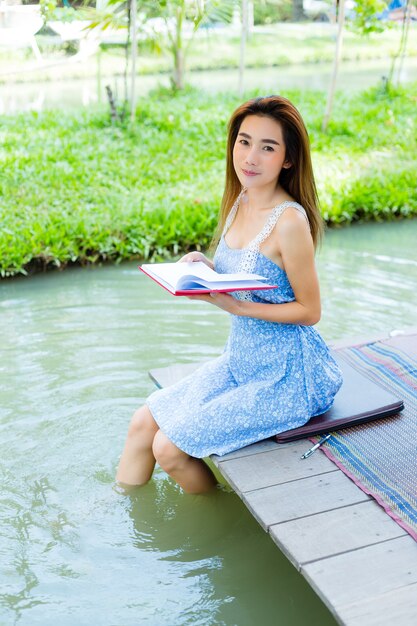 Retrato mujer joven con diario en el parque