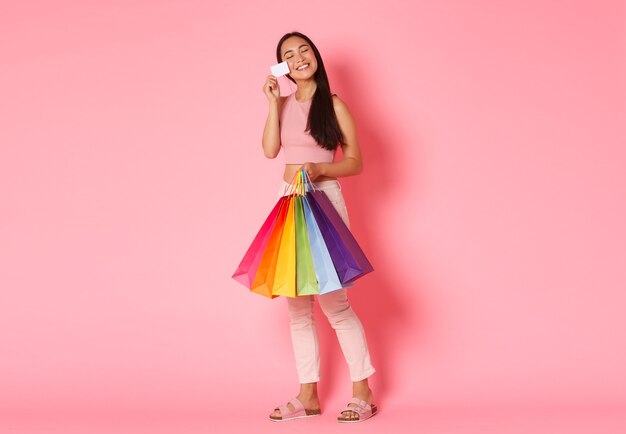 Retrato de mujer joven expresiva con bolsas de la compra.