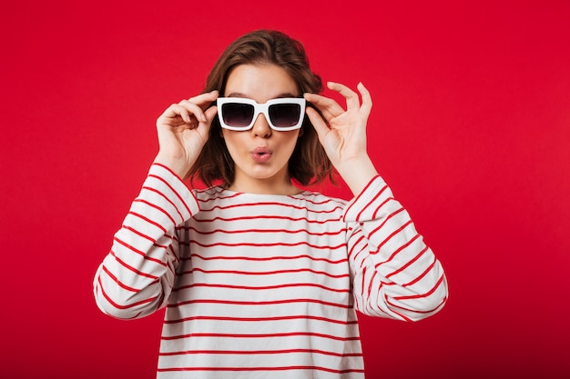 Retrato de una mujer joven en gafas de sol posando