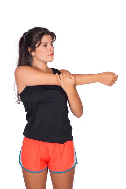 Retrato de mujer joven hermosa deporte con ropa deportiva y estiramiento antes del ejercicio en estudio. Concepto de deporte y estilo de vida.